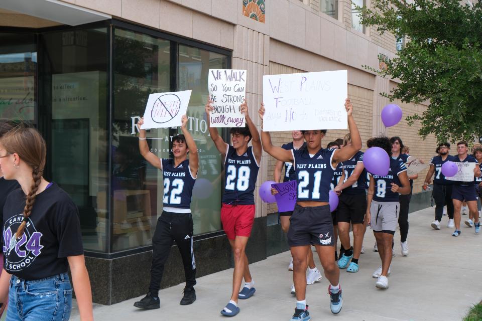 Members of the West Plains High School football team join the walk against domestic violence Monday afternoon in downtown Amarillo.