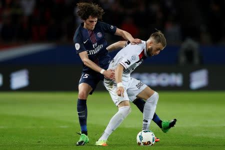 Football Soccer - Paris St Germain v Guingamp - French Ligue 1 - Parc des Princes, Paris, France - 9/4/17. Paris St Germain's Adrien Rabiot and Guingamp's Lucas Deaux in action. REUTERS/Gonzalo Fuentes