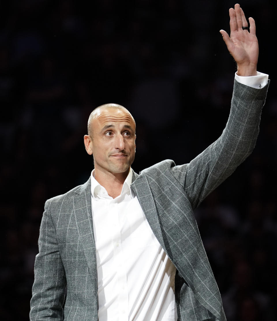 Former San Antonio Spurs guard Manu Ginobili waves to fans during his retirement ceremony after the Spurs' NBA basketball game against the Cleveland Cavaliers, Thursday, March 28, 2019, in San Antonio. San Antonio won 116-110. (AP Photo/Darren Abate)