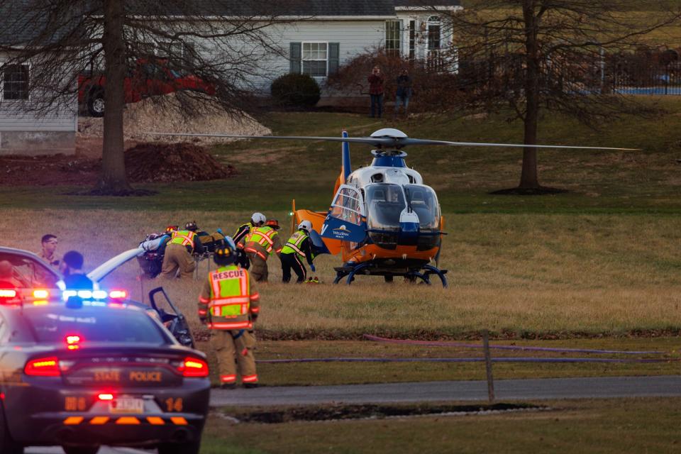 A patient is transported to a medical helicopter to be airlifted at the scene of a vehicle crash with entrapment on the 1900 block of Centennial Road, Sunday, Feb. 4, 2024, in Mount Pleasant Township.