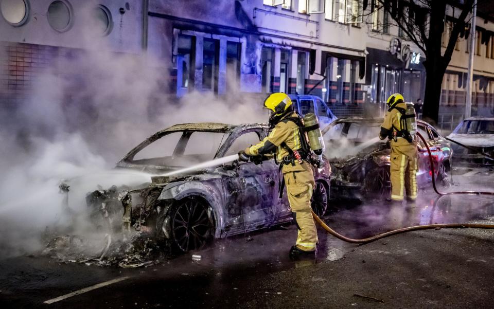 Burning police cars at the Opera hall center on the Fruitweg, The Hague