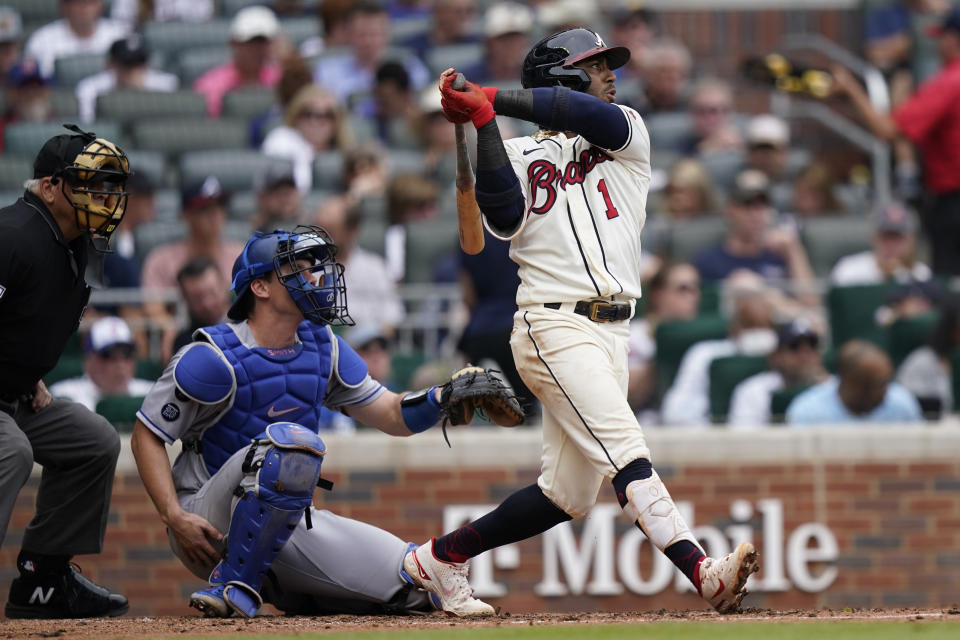 Atlanta Braves second baseman Ozzie Albies (1) drives in a run with a double as Los Angeles Dodgers catcher Will Smith (16) looks on in the third inning of a baseball game Sunday, June 6, 2021, in Atlanta. (AP Photo/Brynn Anderson)