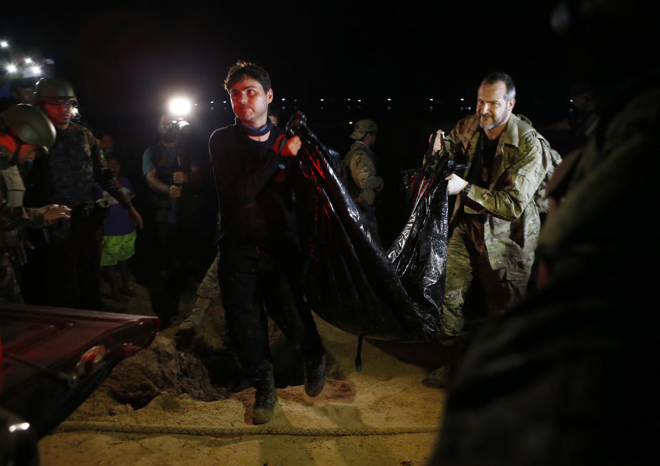 Federal police officers arrive at the pier with recovered human remains found during a search for Indigenous expert Bruno Pereira of Brazil and freelance reporter Dom Phillips of Britain, in Atalaia do Norte, Amazonas state, Brazil, Wednesday, June 15, 2022. A federal police investigator said a suspect confessed to fatally shooting Pereira and Phillips in a remote part of the Amazon and took officers to where the bodies were buried. (AP Photo/Edmar Barros)