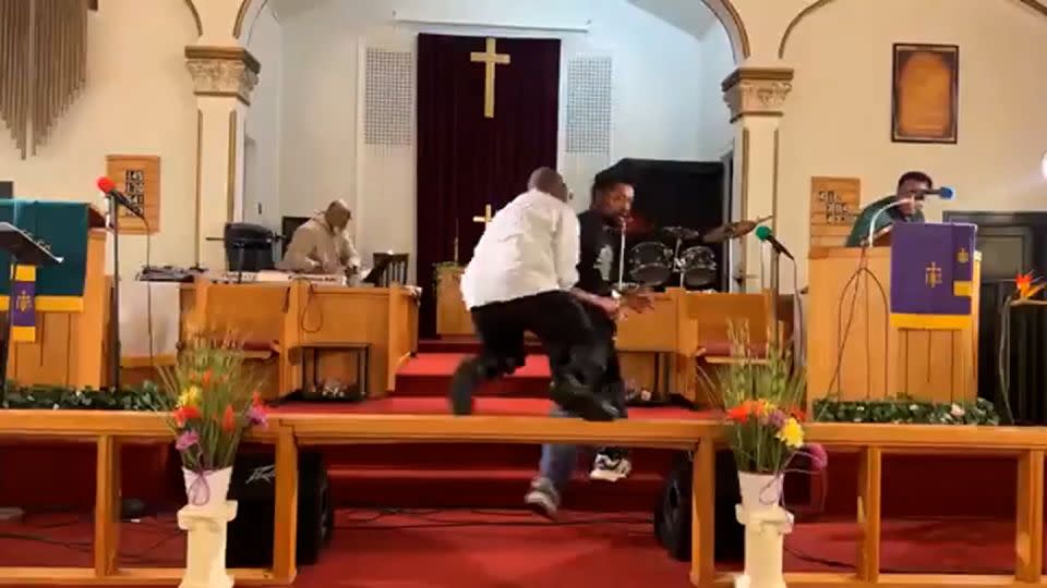 Clarence McCallister flies over a railing to tackle a gunman at Jesus’ Dwelling Place Church in North Braddock, Pennsylvania. - Glenn Germany/TMX