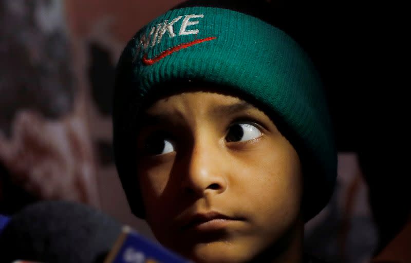 Mohammed Ali, son of Asif, who died during clashes with police following protests against a new citizenship law, sits inside his house in Meerut