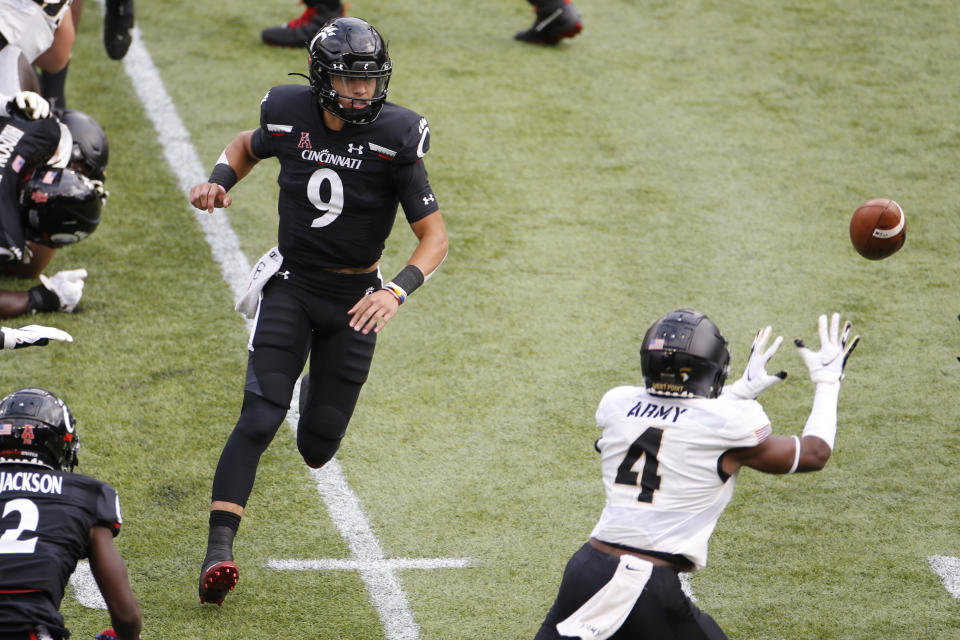 Army defensive back Jabari Moore, right, intercepts a pitch from Cincinnati quarterback Desmond Ridder during the first half of an NCAA college football game Saturday, Sept. 26, 2020, in Cincinnati, Ohio. Moore scored a touchdown on the play. (AP Photo/Jay LaPrete)