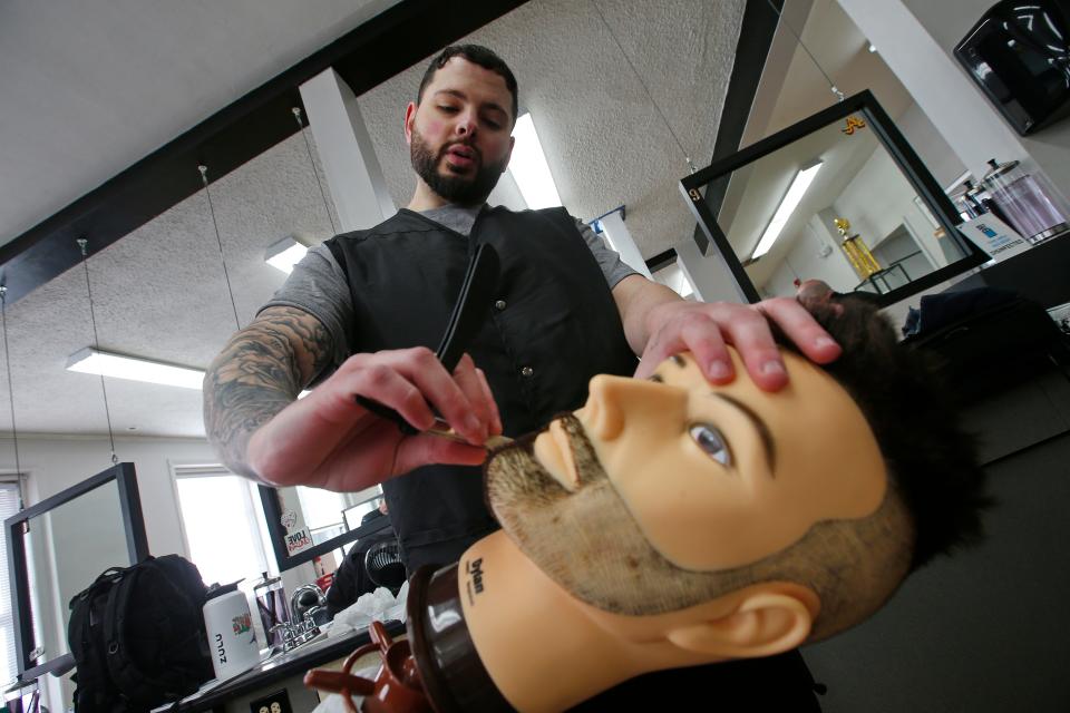 Nick Moniz works on his shaving stroke order using a razor at the Rob Roy Academy in Fall River.