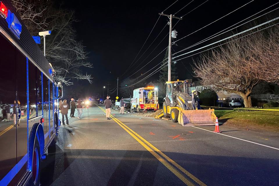 First responders work the scene of a crash in Waltham, Mass., after a person in a vehicle struck and injured utility workers before stealing a police cruiser, Wednesday, Dec. 6, 2023. The driver in the suburb of Boston crashed the cruiser before being captured, law enforcement officials said. (AP Photo/Michael Casey) ORG XMIT: MAMC103