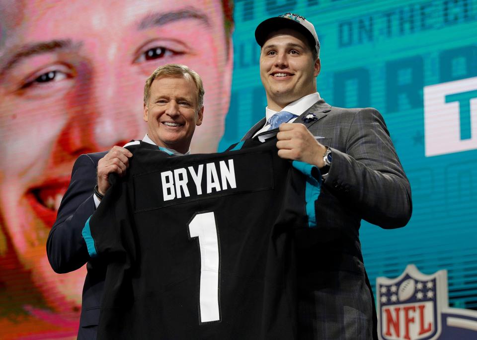 Commissioner Roger Goodell presents Florida's Taven Bryan with his Jacksonville Jaguars team jersey during the first round of the NFL football draft, Thursday, April 26, 2018, in Arlington, Texas. (AP Photo/David J. Phillip)