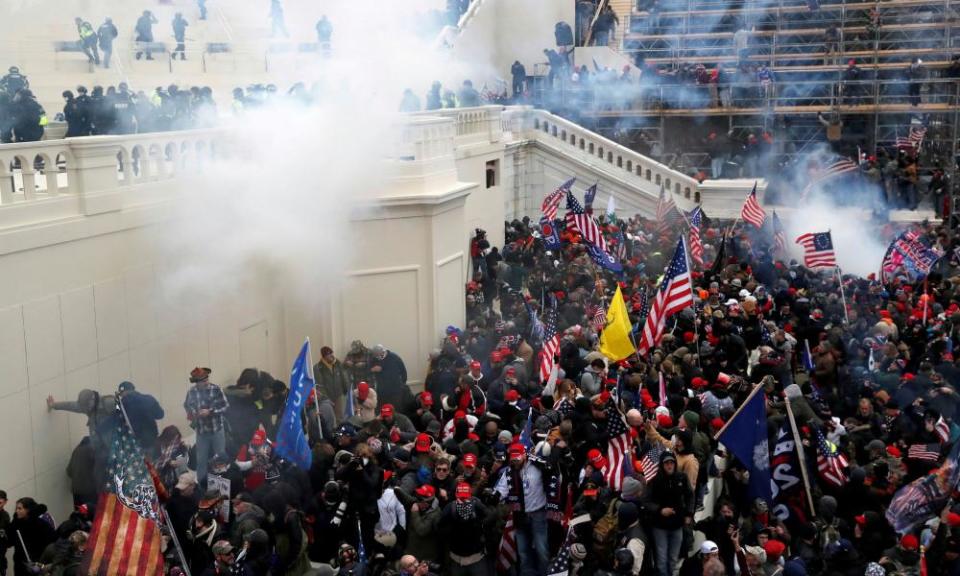 Police release tear gas into a crowd of pro-Trump rioters at the US Capitol building in Washington.