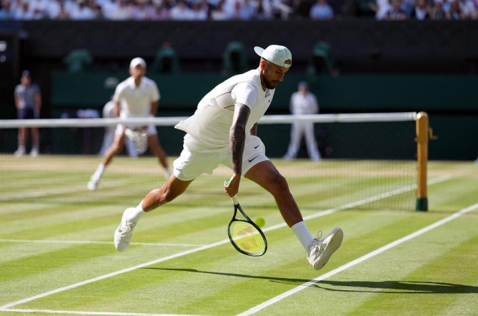 Nick Kyrgios plays a shot through his legs during his Wimbledon final against Novak Djokovic (PA)