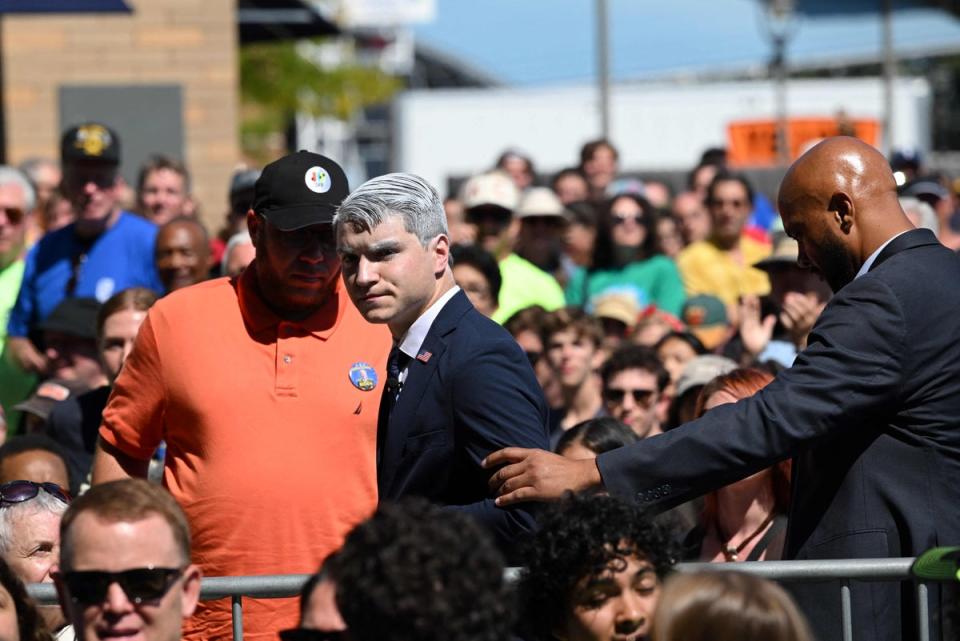 A man who heckled US President Joe Biden as he spoke is removed (AFP via Getty Images)