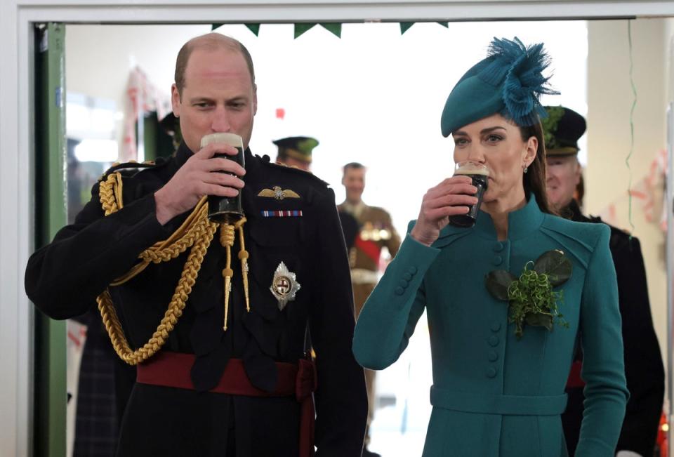 Prince William, the Prince of Wales and Kate, the Princess of Wales drink Guinness, during the St. Patrick's Day Parade at Mons Barracks, in Aldershot, England, Friday, March 17, 2023 (AP)