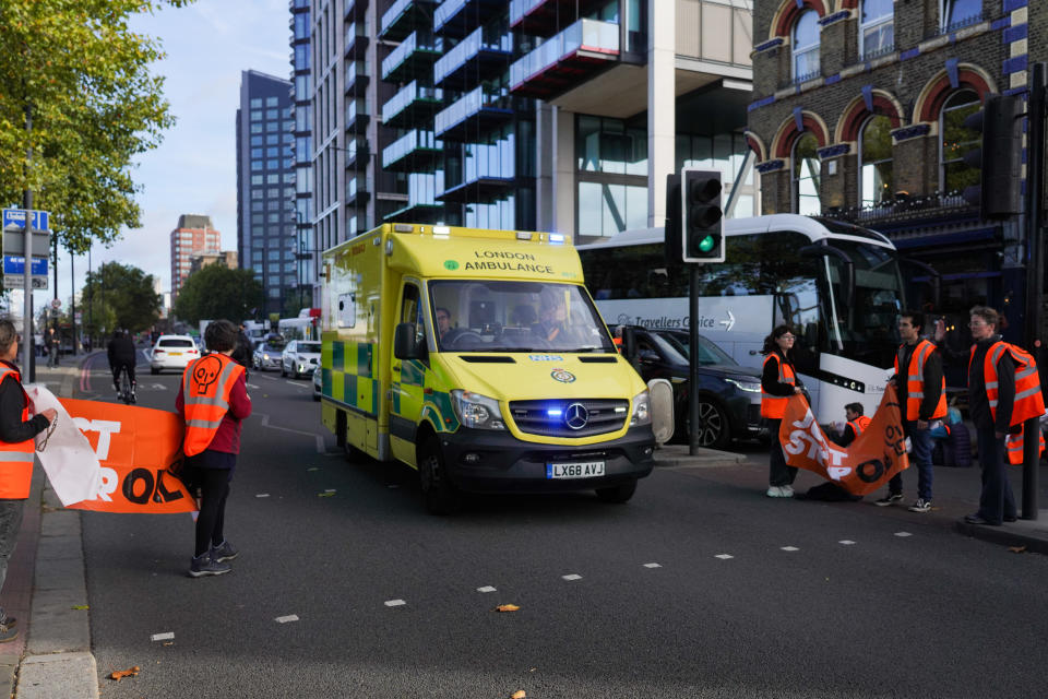 Just Stop Oil climate activists block traffic on the 7th of October 2022, Central London, United Kingdom. The activists sat down in the road, some super glued to the road. An ambulance is let through the blockade. The peaceful action created traffic chaos in the morning while police cleared the road. A number of activists were arrested. The action is part of an ongoing campaign by Just Stop Oil. The activists demand the UK government takes the climate crisis serious and stop all new oil and gas extraction. In spite of the ongoing climate crisis and potential cataclysmic climate change due to fossil fuel emissions, the UK government is planning to open up more than 100 new oil and gas fields and potentially fracking as well. Just Stop Oil aim to disrupt Westminster in Central London with civil disobedience through-out October to get their demands heard. (photo by Kristian Buus/In Pictures via Getty Images)