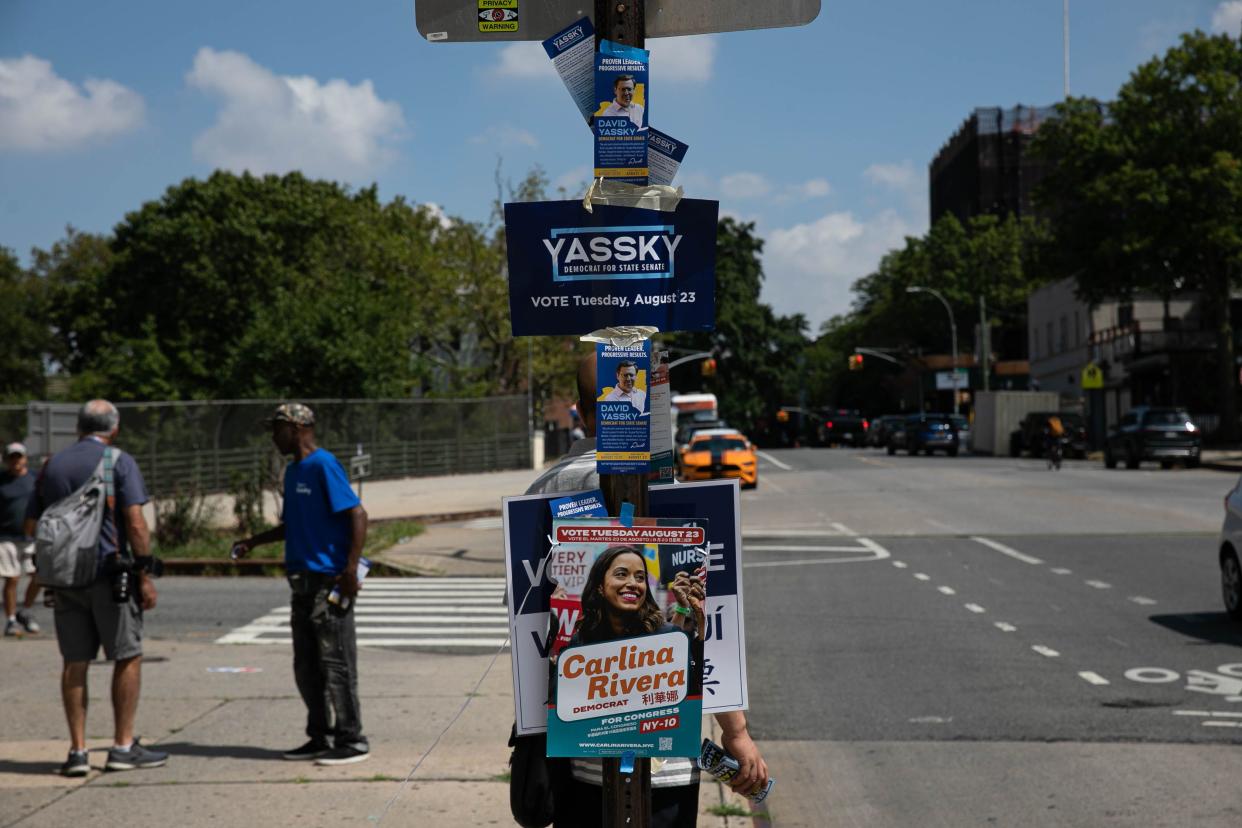 Campaign signs are pictured on Tuesday near poll sites in South Slope in Brooklyn. 