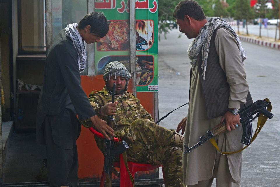 Members of Afghan security forces guard along the roadside in Panjshir province on August 14, 2021.