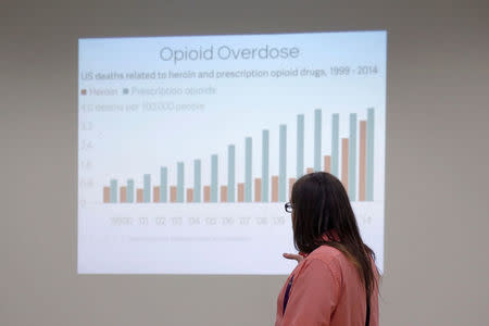 Thomas Womelsdorf, a Prevention Care Manager with the Southern Tier AIDS Program, looks toward a chart depicting opioid overdose statistics during a free Opioid Overdose Prevention Training class provided by Lourdes Hospital in Binghamton, New York, U.S., April 5, 2018. REUTERS/Andrew Kelly