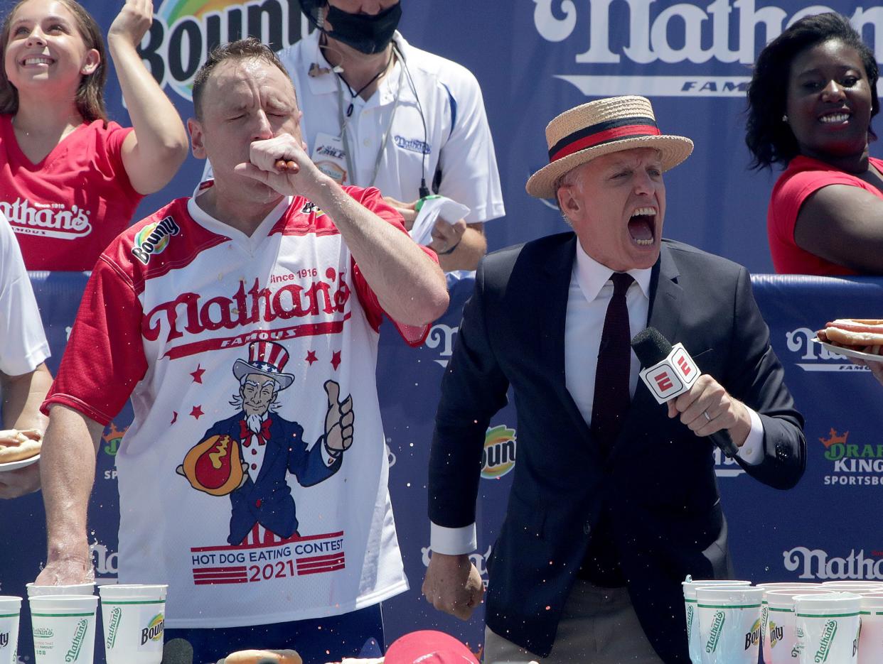 Competitive eater Joey Chestnut, left, competes in the Nathan's Fourth of July Hot Dog Eating Contest in Coney Island, Brooklyn on July 4. 