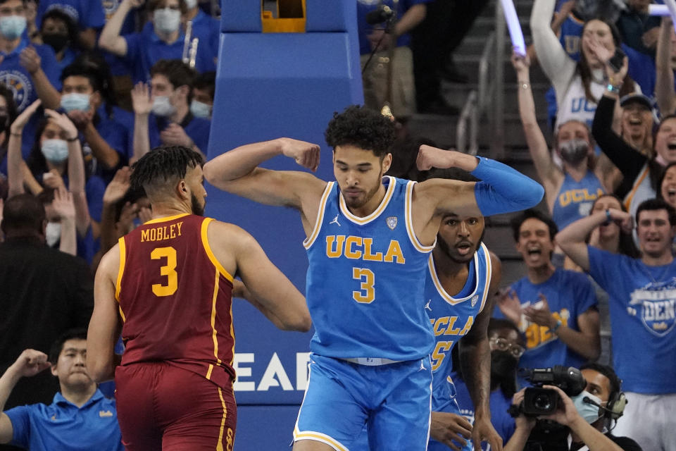 UCLA guard Johnny Juzang, right, celebrates after scoring as Southern California forward Isaiah Mobley, left, stands by during the first half of an NCAA college basketball game Saturday, March 5, 2022, in Los Angeles. (AP Photo/Mark J. Terrill)