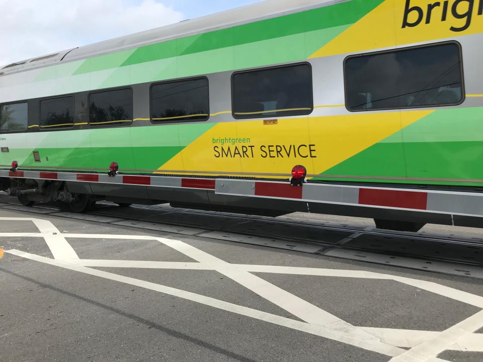 A Brightline passenger car shown passing over a crossing at 21st Street near Commerce Avenue off U.S. 1 in Vero Beach on Thursday, October 12, 2023.