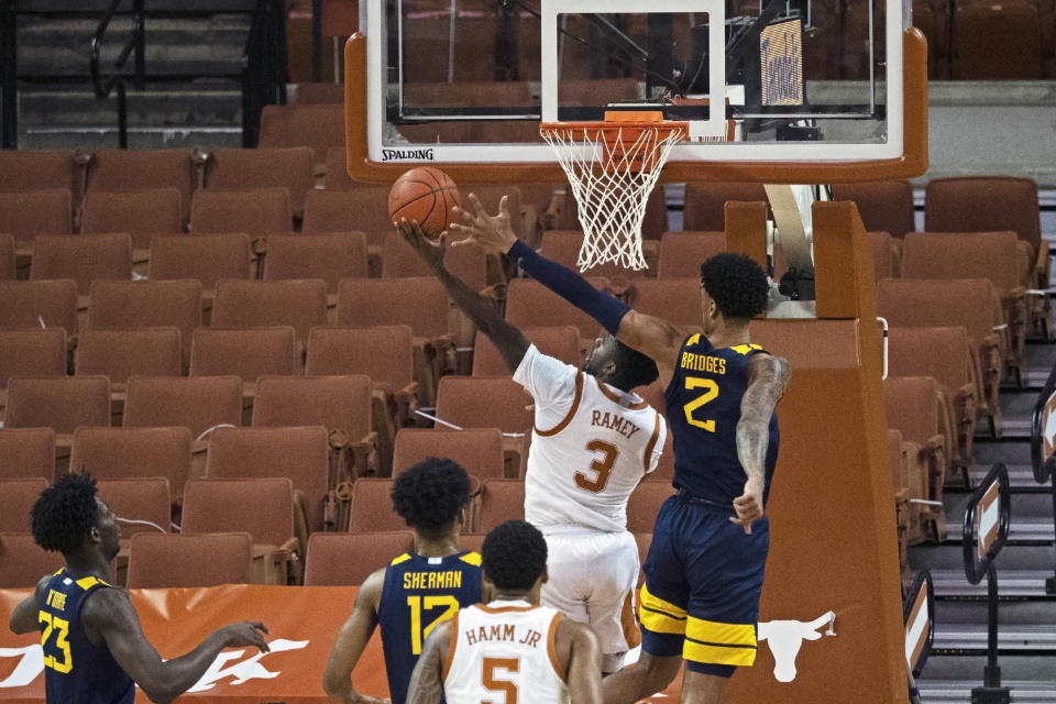 West Virginia forward Jalen Bridges (2) defends a shot by Texas guard Courtney Ramey (3) during the first half of an NCAA college basketball game, Saturday, Feb. 20, 2021, in Austin, Texas. (AP Photo/Michael Thomas)