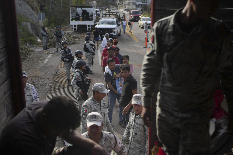 Soldiers stand guard during a food delivery, in the aftermath of Hurricane Otis in Acapulco, Mexico, Saturday, Oct. 28, 2023. (AP Photo/Felix Marquez)