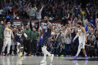 Dallas Mavericks guard Kyrie Irving (11) and the crowd react after he scored the winning final-second basket in an NBA basketball game against the Denver Nuggets in Dallas, Sunday, March 17, 2024. (AP Photo/LM Otero)