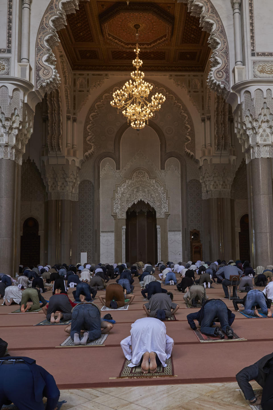 Moroccans wear face masks and pray respecting social distancing at the great Hassan II Mosque in Casablanca, Morocco, Friday, Oct. 16, 2020. In Morocco today, around 10,000 mosques have opened their doors for the faithful to perform the Friday. For the first time since the outbreak of coronavirus in March, Morocco has allowed mosques to reopen for Friday prayers. (AP Photo / Abdeljalil Bounhar)