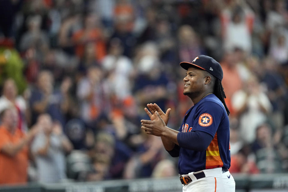 Houston Astros starting pitcher Framber Valdez smiles as he is applauded by fans during the seventh inning of a baseball game against the Oakland Athletics after making a Major League Baseball record 25 consecutive quality starts Sunday, Sept. 18, 2022, in Houston. (AP Photo/David J. Phillip)