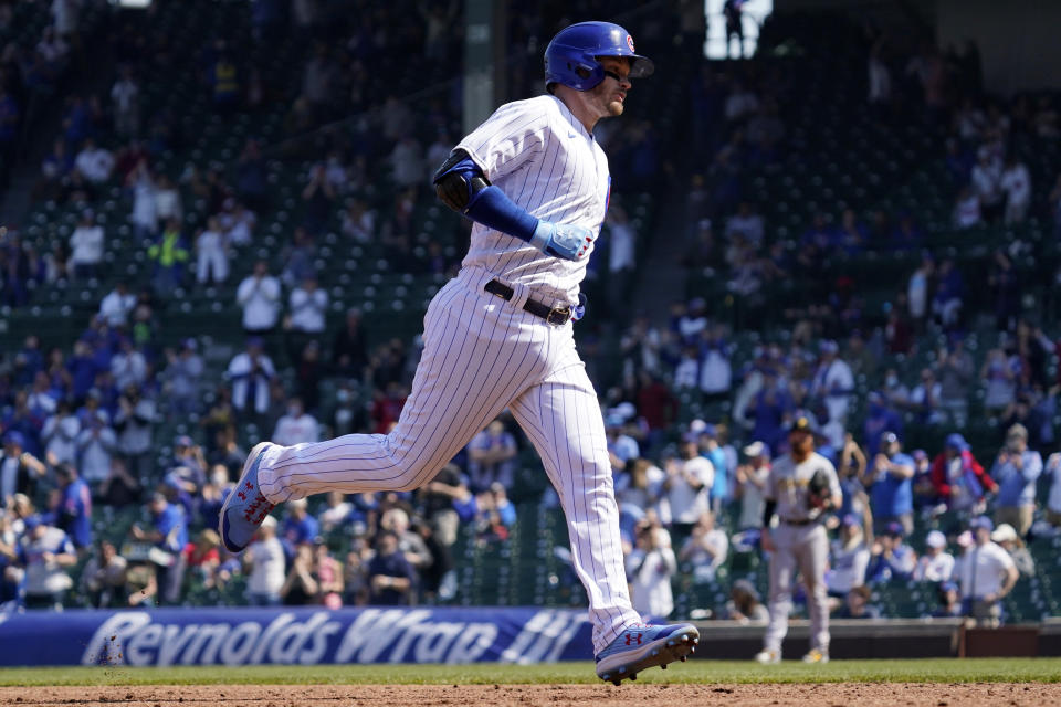 Chicago Cubs' Ian Happ rounds the bases after hitting a solo home run during the third inning of a baseball game against the Pittsburgh Pirates in Chicago, Sunday, April 4, 2021. (AP Photo/Nam Y. Huh)