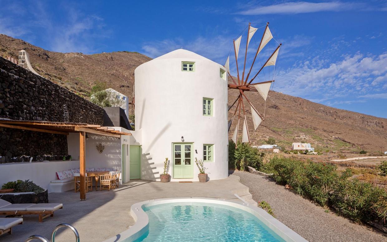 White villa shaped like a windmill