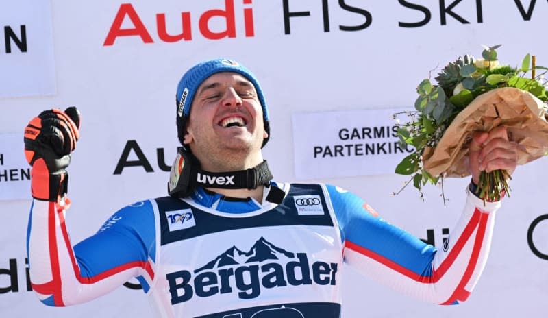 France's first-placed Nils Allegre celebrates on the podium after the men's Super-G race during the Alpine skiing World Cup in Garmisch-Partenkirchen. Angelika Warmuth/dpa