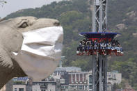 People wearing face masks as a precaution against the coronavirus ride Gyro Drop as they visit to celebrate Children's Day at Children's Grand Park in Seoul, South Korea, Wednesday, May 5, 2021. (AP Photo/Ahn Young-joon)