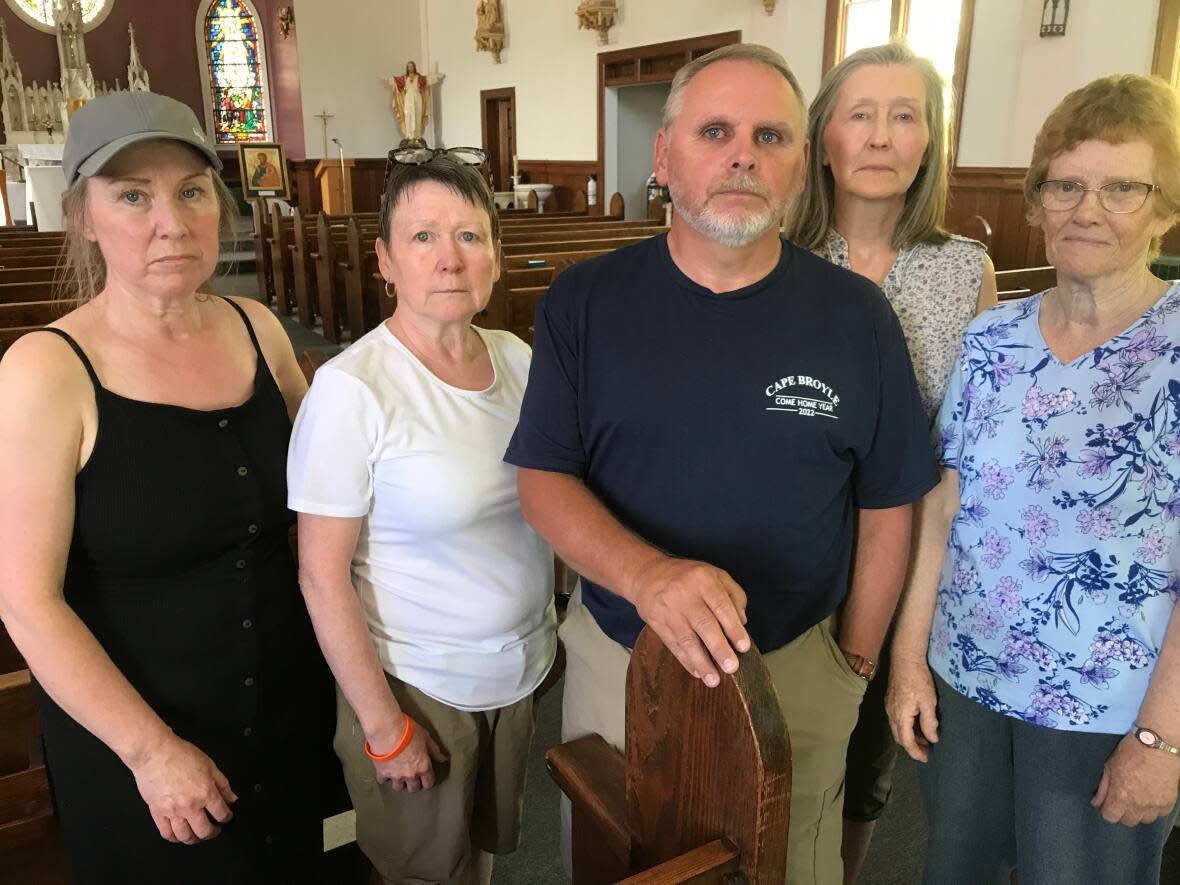 The maintenance committee at Immaculate Conception Roman Catholic Church in Cape Broyle has expanded its mandate. The church went up for sale this week, and now they're desperately trying to find a way to buy their church and preserve the landmark as a place of worship. Pictured here are, from left, Carolyn Hawkins, Paula Hawkins, Wayne Kenney, Sharon Mulcahy and Elizabeth Whelan. (Terry Roberts/CBC - image credit)