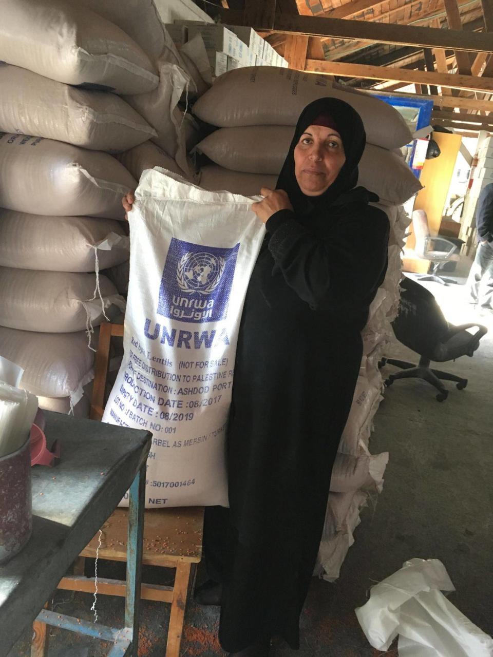 A refugee helper at the Beach Camp food aid centre on Monday (Sarah Helm)