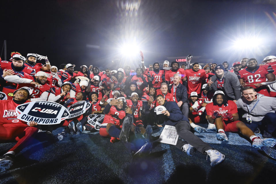 Liberty celebrate the team's win over New Mexico State during the Conference USA championship NCAA college football game Friday, Dec. 1, 2023, in Lynchburg, Va. (Paige Dingler/The News & Advance via AP)