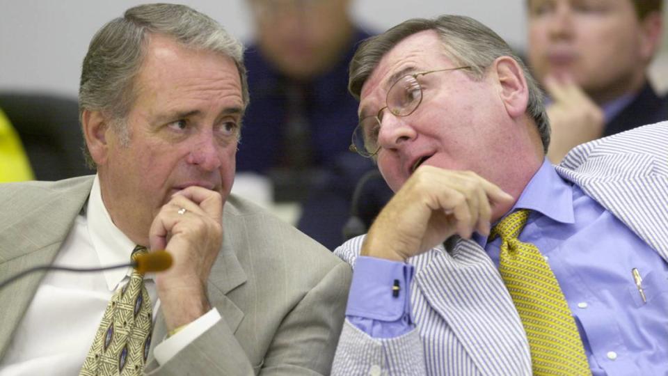 State Senator David Hoyle (left), and Sen. Tony Rand discuss the new State redistricting map during a 2001 meeting of the Senate Redistricting Committee.