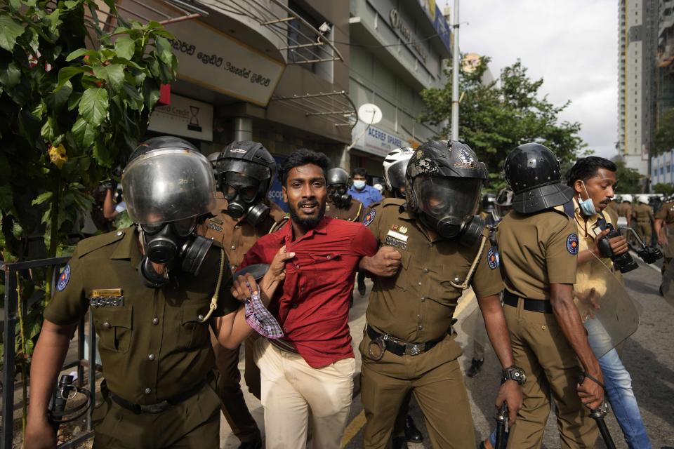 Police officers detain an anti-government protester in Colombo, Sri Lanka, Thursday, Aug. 18, 2022. (AP Photo/Eranga Jayawardena)