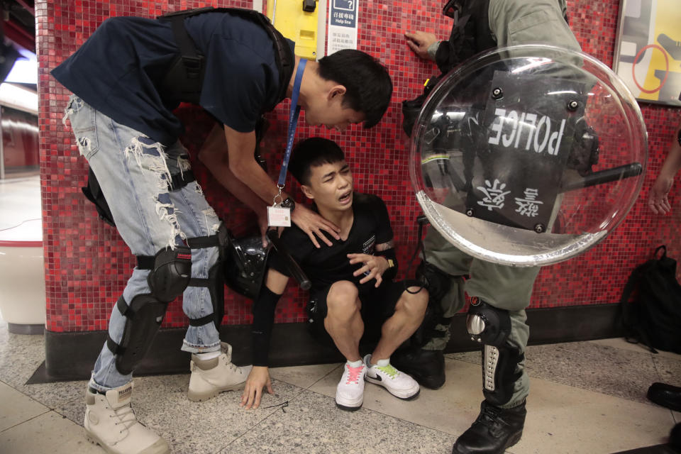 Police detain a protester, center, after he blocked train door at a subway station in Hong Kong, on Monday, Sept. 2, 2019. Hong Kong has been the scene of tense anti-government protests for nearly three months. The demonstrations began in response to a proposed extradition law and have expanded to include other grievances and demands for democracy in the semiautonomous Chinese territory. (AP Photo/Jae C. Hong)