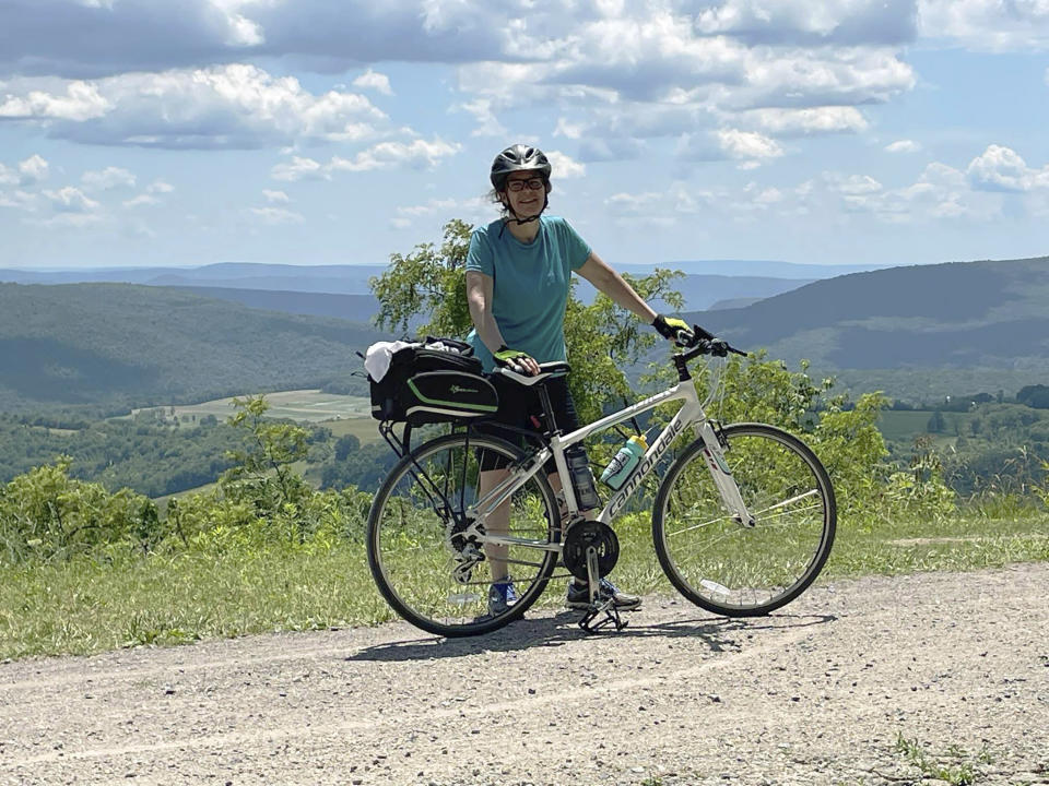 April Herring poses with her bike along the Chesapeake & Ohio Canal on July 2, 2021. (Kellie A. Tikkun via AP)