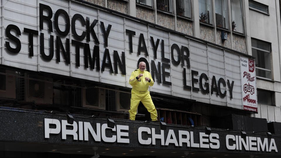 British stuntman Rocky Taylor, aged 64, poses above the entrance of the Prince Charles Cinema in central London. (Credit: PA)