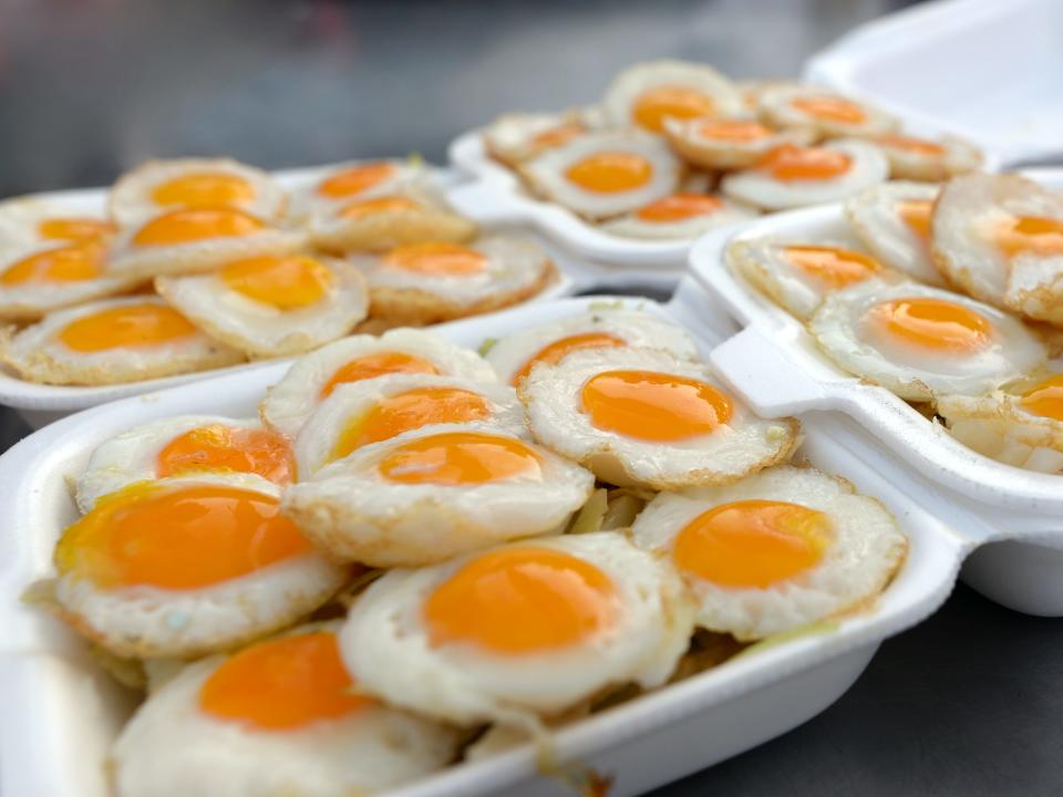 fried quail eggs in styrofoam takeout boxes