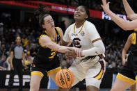 Iowa guard Caitlin Clark, left, tries to steal the ball from South Carolina forward Sania Feagin during the first half of the Final Four college basketball championship game in the women's NCAA Tournament, Sunday, April 7, 2024, in Cleveland. (AP Photo/Morry Gash)