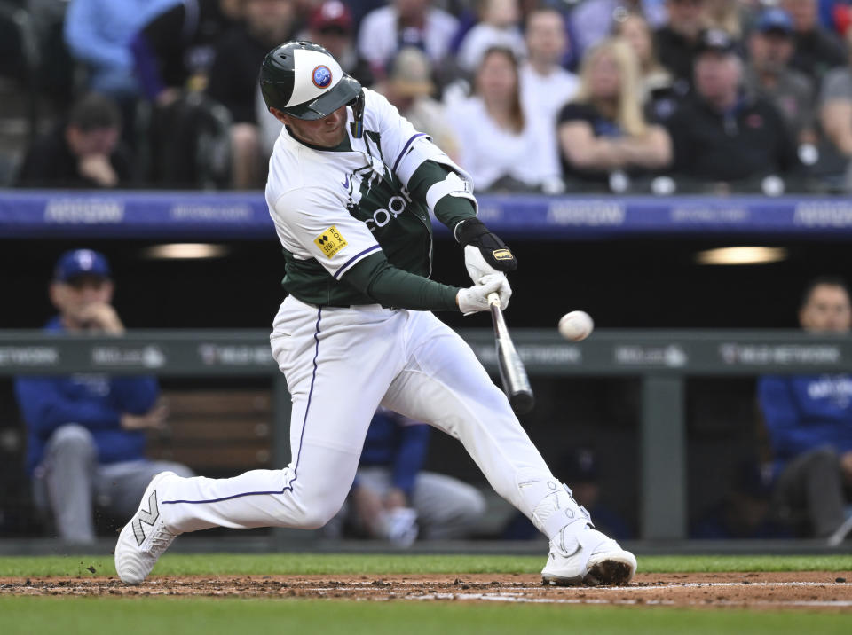 Colorado Rockies' Hunter Goodman hits a home run in the third inning of a baseball game against the Texas Rangers, Saturday, May 11, 2024, in Denver. (AP Photo/Jerilee Bennett)