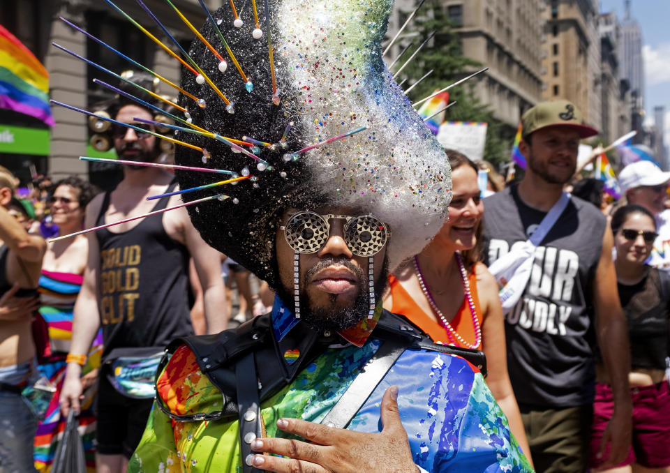 People walk along 5th Ave. as they participate in the LBGTQ Pride march Sunday, June 30, 2019, in New York. (AP Photo/Craig Ruttle)