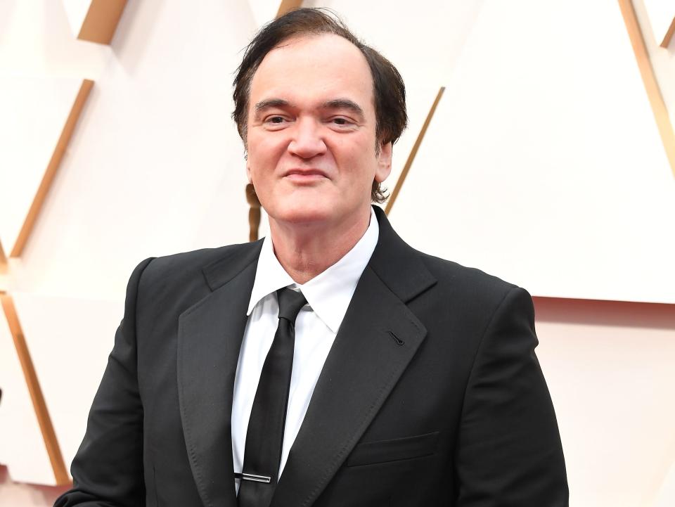 Quentin Tarantino in a black suit with black tie