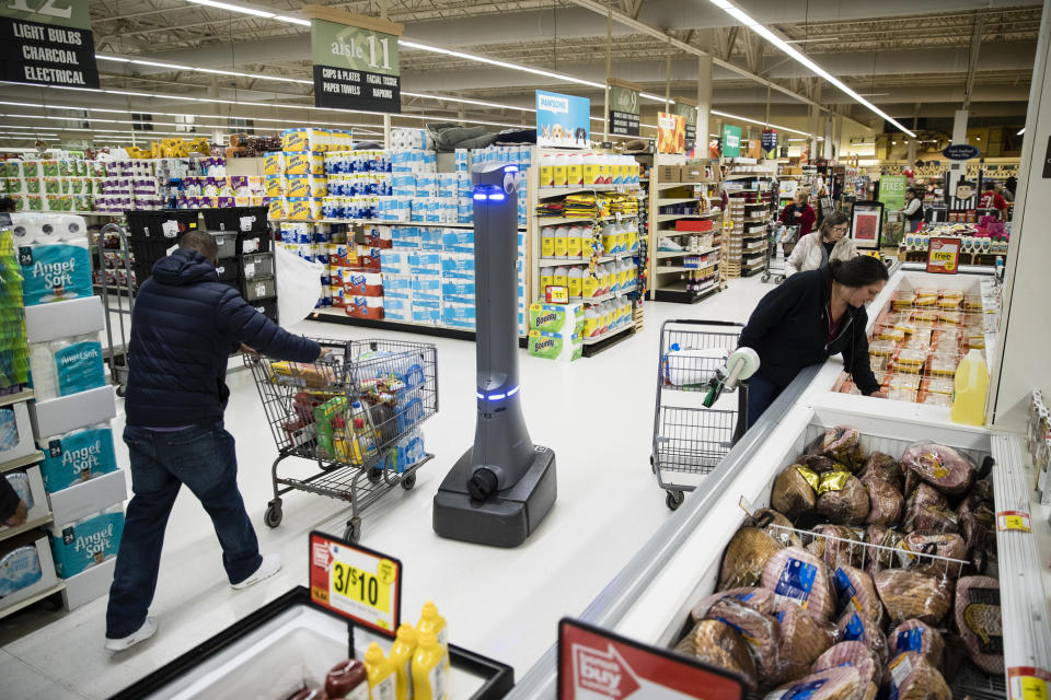 FILE- In this Jan. 15, 2019, file photo a robot named Marty cleans the floors at a Giant grocery store in Harrisburg, Pa. Robots aren’t replacing everyone, but a quarter of U.S. jobs will be severely disrupted as artificial intelligence accelerates the automation of today’s work, according to a new Brookings Institution report. The report published Thursday, Jan. 24, says roughly 36 million Americans hold jobs with “high exposure” to automation, meaning about 70 percent of their work tasks could soon be performed by machines using current technology. (AP Photo/Matt Rourke, File)