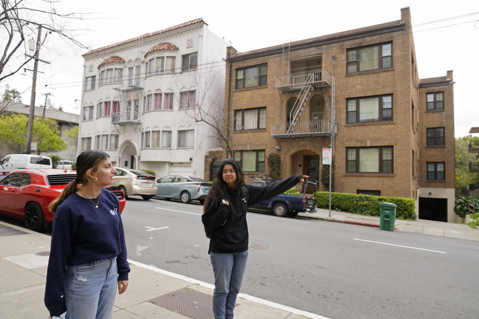 University of California, Berkeley freshmen Sanaa Sodhi, left, and Cheryl Tugade look for apartments in Berkeley, Calif., Tuesday, March 29, 2022. Millions of college students in the U.S. are trying to find an affordable place to live as rents surge nationally, affecting seniors, young families and students alike. Sodhi is looking for an apartment to rent with three friends next fall, away from the dorms but still close to classes and activities on campus. They've budgeted at least $5,200 for a two-bedroom. (AP Photo/Eric Risberg)