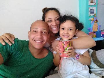 Juan Vargas poses for a photo with his wife and their daughter in Peru. / Credit: Juan Vargas