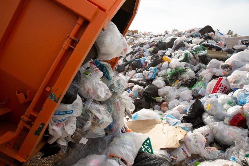 A roll-off dumpster full of recycled plastic is emptied at Tank's Speedway Recycling and Landfill in Tucson on Thursday, May 18, 2023.